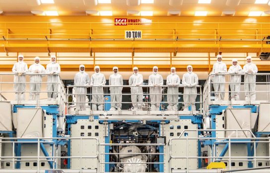 A group of people in "bunny suits" in the OMEGA Laser Facility