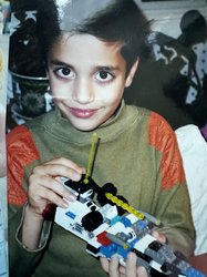 Arian Jadbabaie as. child, holding a Lego ship.