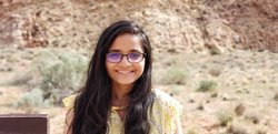 Sneha Aenugu standing outdoors in a desert setting