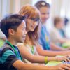 Smiling children working at computers