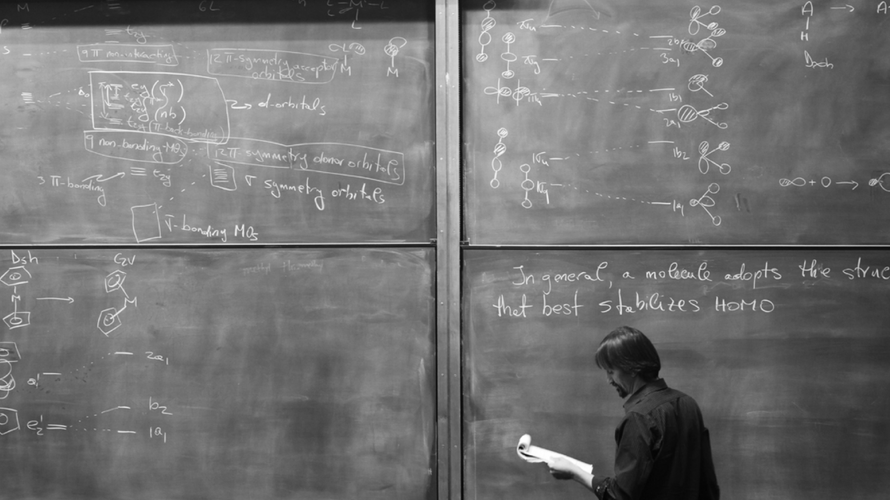 A professor at the blackboard during chemistry class