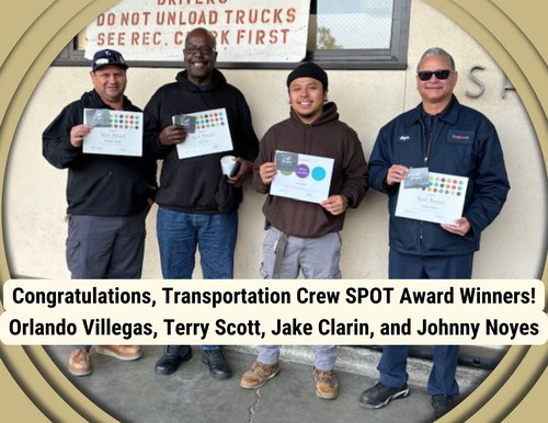 Four men holding certificates of appreciation