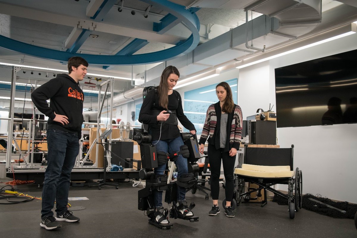 Maegan (center) testing the responsiveness of an exoskeleton.