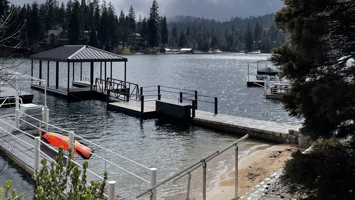 Sunny view of lake, beach and jetty