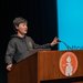 Aaron Zhao speaks behind a podium