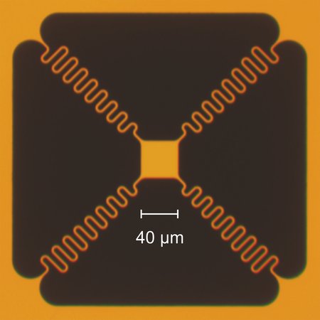 An image of the miniature lightsail tethered at the corners showing a 40 micron scale bar. The interior "trampoline" is a square with sides that are 40 microns in length.