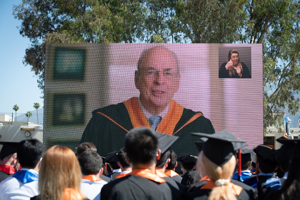 Commencement speaker Norman R. Augustine on a video screen