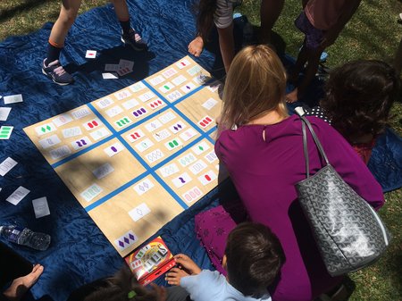 Families collaborated on a challenging variation of the game SET in which players create a quilt of mathematical patterns.