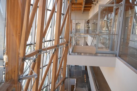 Lots of glass and mass timber framing dominates this view of the new RSC building, which shows part of the third floor, looking down to lower floors.