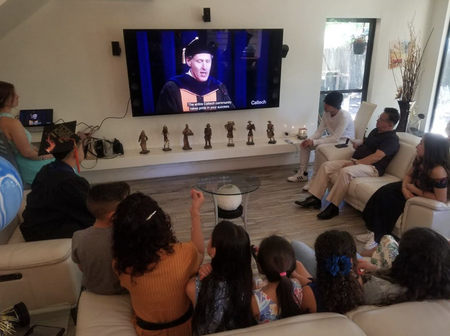 A graduating student's family gathers to watch Caltech's virtual commencement celebration.