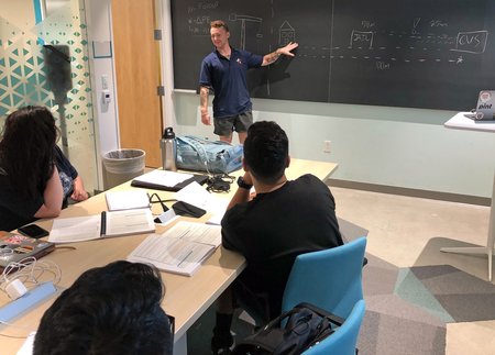 WSP STEM Fellow Shane Rice discusses a physics problem set with his class.