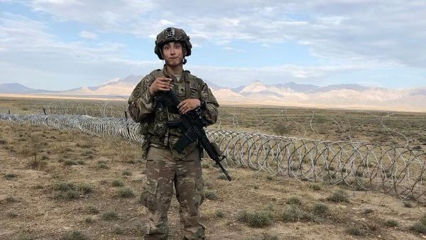 Man in military uniform in a field