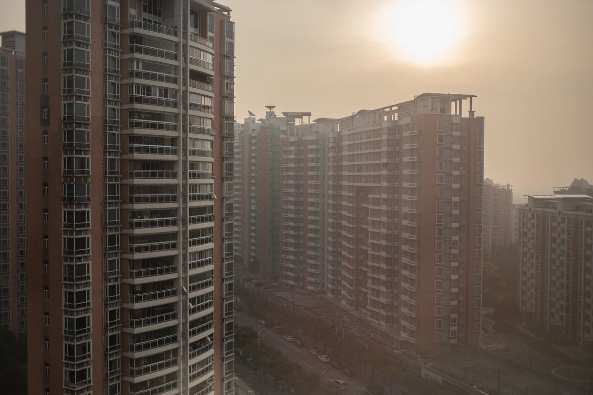 High-rise apartment buildings are shrouded by air pollution in Shanghai.