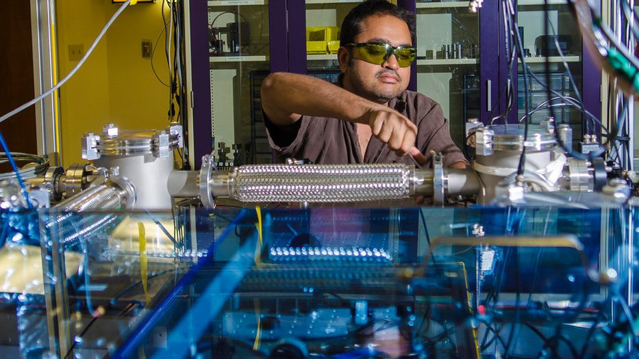 Photo of Rana Adhikari working in his lab