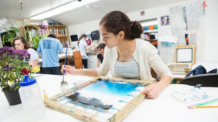 Student painting on canvas