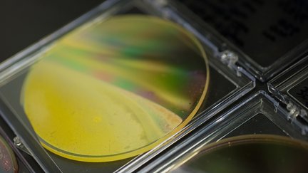 A yellow disc in a clear frame is displayed as a component in the effort to develop liquid fuels from sunlight.