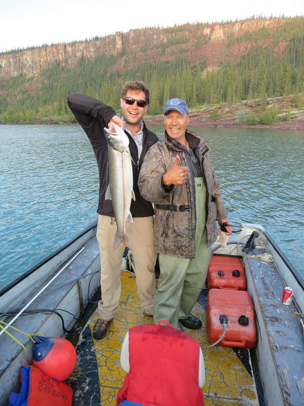 Holding a Mackinaw Trout (lake trout) on a small boat in the East Arm of Great Slave Lake, Northwest Territories, Canada