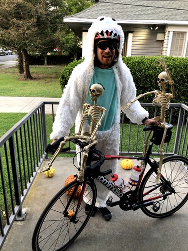 A fellow participant in a Halloween costume with skeletons on his bike.
